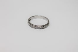 An 18ct white gold diamond half eternity ring,