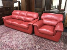 A red leather three seater settee and armchair
