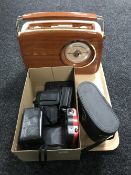 A tray containing a Bush retro style radio, assorted cameras,