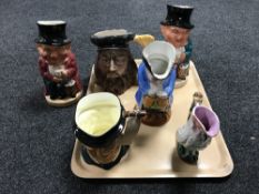A tray of Majolica style parrot jug and five assorted toby jugs