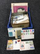 A basket containing a large quantity of loose stamps,