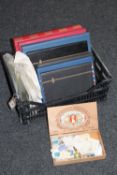 A basket containing seven stamp albums containing British and stamps of the world,