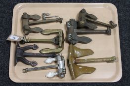 A tray containing eight metal anchors