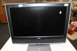 A Toshiba Regza twenty six inch LCD TV with remote
