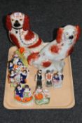 A tray containing two Staffordshire dogs, Staffordshire spill vase,