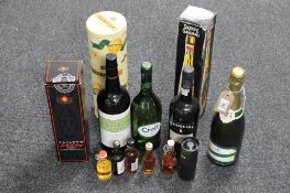 A bottle of Veuve Hennerick champagne together with a box containing alcohol including port, sherry,