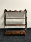 A set of mahogany wall shelves fitted three drawers