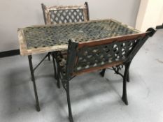 A cast iron and wood garden table,