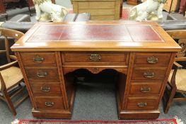 A late Victorian walnut pedestal desk with tooled burgundy leather top,