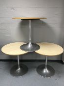 Three circular cafe tables on metal pedestals