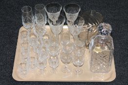 A tray containing lead crystal decanters and assorted drinking glasses,