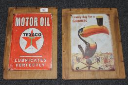 Two metal advertising signs mounted on pine boards,