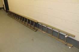 A wooden ladder together with a small wooden extension ladder