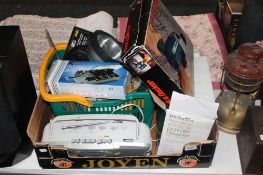 A box containing Black and Decker drill, steam cleaner, torches, battery charger, radio, tools,