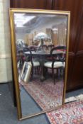 A large gilt framed bevelled overmantel mirror
