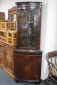 A mahogany corner display cabinet