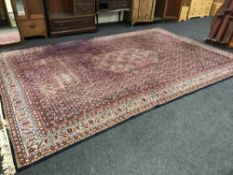 A large woollen floral carpet on blue ground