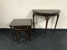 A nest of three inlaid mahogany glass topped tables,