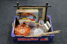 A box containing a set of brass stair rods, carnival glass bowls, vintage party games,
