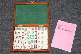 A mahjong set in carved wooden box
