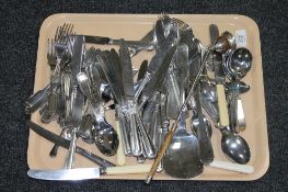 A tray containing a quantity of table cutlery, servers,