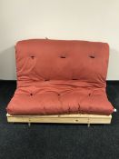 A pine futon with mattress