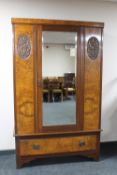 A late Victorian mahogany and walnut mirror door wardrobe