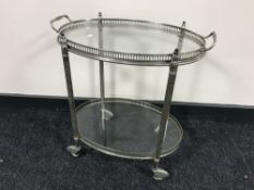 A chrome two tier serving trolley with lift off gallery tray