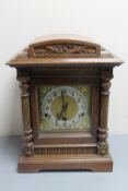 An antique mahogany cased German mantel clock with brass dial
