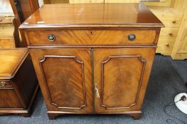 A mahogany Siesta double door cabinet, fitted a drawer,