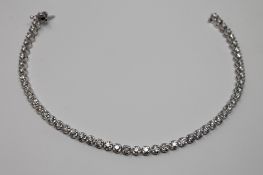 An impressive 18ct white gold diamond tennis bracelet, approximately 6ct, 19.2g, length 23.5cm.