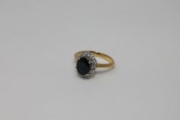 An 18ct gold sapphire and diamond cluster ring,