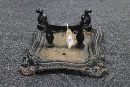 A cast iron boot scraper