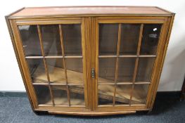 An Edwardian mahogany double door bookcase with glazed panel doors