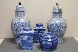 A pair of Adams blue and white lidded vases in an oriental style,
