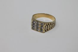 An 18ct gold Gentleman's Rolex style nine stone diamond ring, size W.