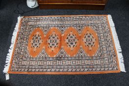 A Persian rug of geometric design on peach ground 78 cm x 120 cm