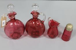 A pair of cranberry glass decanters,