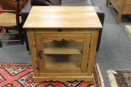 A pine glazed low cupboard, width 63.