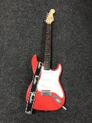 A Fender Squire Bullet Strat Guitar with carry strap