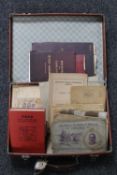 A mid twentieth century leather case containing cigarette cards and albums, ordinance survey books,