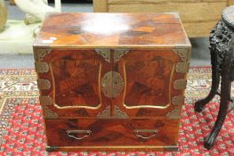 A Chinese metal mounted double door cabinet, fitted a drawer,