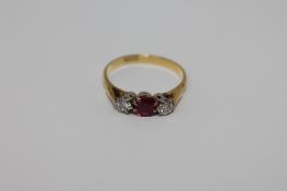 An 18ct gold ruby and two stone diamond ring, size O/P, 3.3g.
