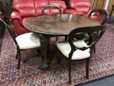 A Victorian mahogany wind out table on claw and ball feet together with four reproduction mahogany