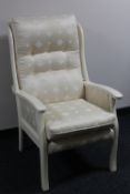 A contemporary armchair in a cream fabric