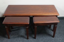 A nest of three Stag coffee tables in a mahogany finish