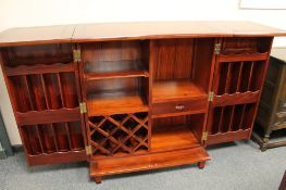 An Oriental style hardwood concertina bar, fully extended width 192.