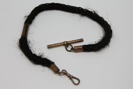 A Victorian hair Albert with gold fittings