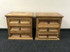 A pair of heavy pine three drawer bedside chests