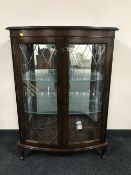 A mahogany bow fronted double door display cabinet